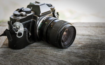 Retro vintage classic camera film on wood background