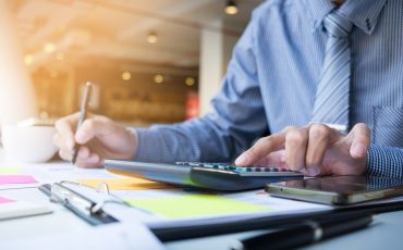 Image of a financial advisor at work to accompany a guest blog article from Nick Bone, Financial Advisor at Greenwood Mortgages, on the 60% tax trap and what higher earners need to know